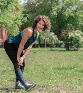 Junge Frau auf einer Raststätte macht Übung Bein Stretch