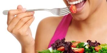 Frau isst Tomaten Salat mit Gabel Tomaten sind ein natürlicher Appetitzügler