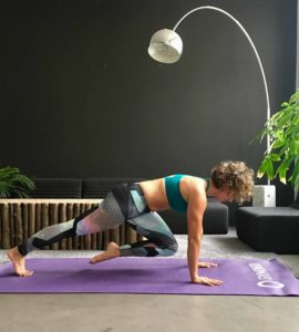 Frau macht Mountain Climbers auf lila trainingsmatte