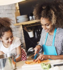 Mutter und Kind kochen gemeinsam gesund in der Küche