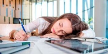 nachmittagsloch_353 Frau schläft auf Schreibtisch